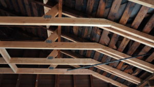 Photo of wooden trusses supporting a wooden roof.