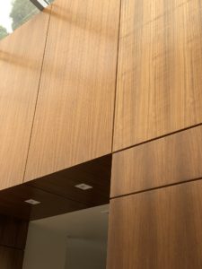 Close up photo of wood cabinetry within a modern house.